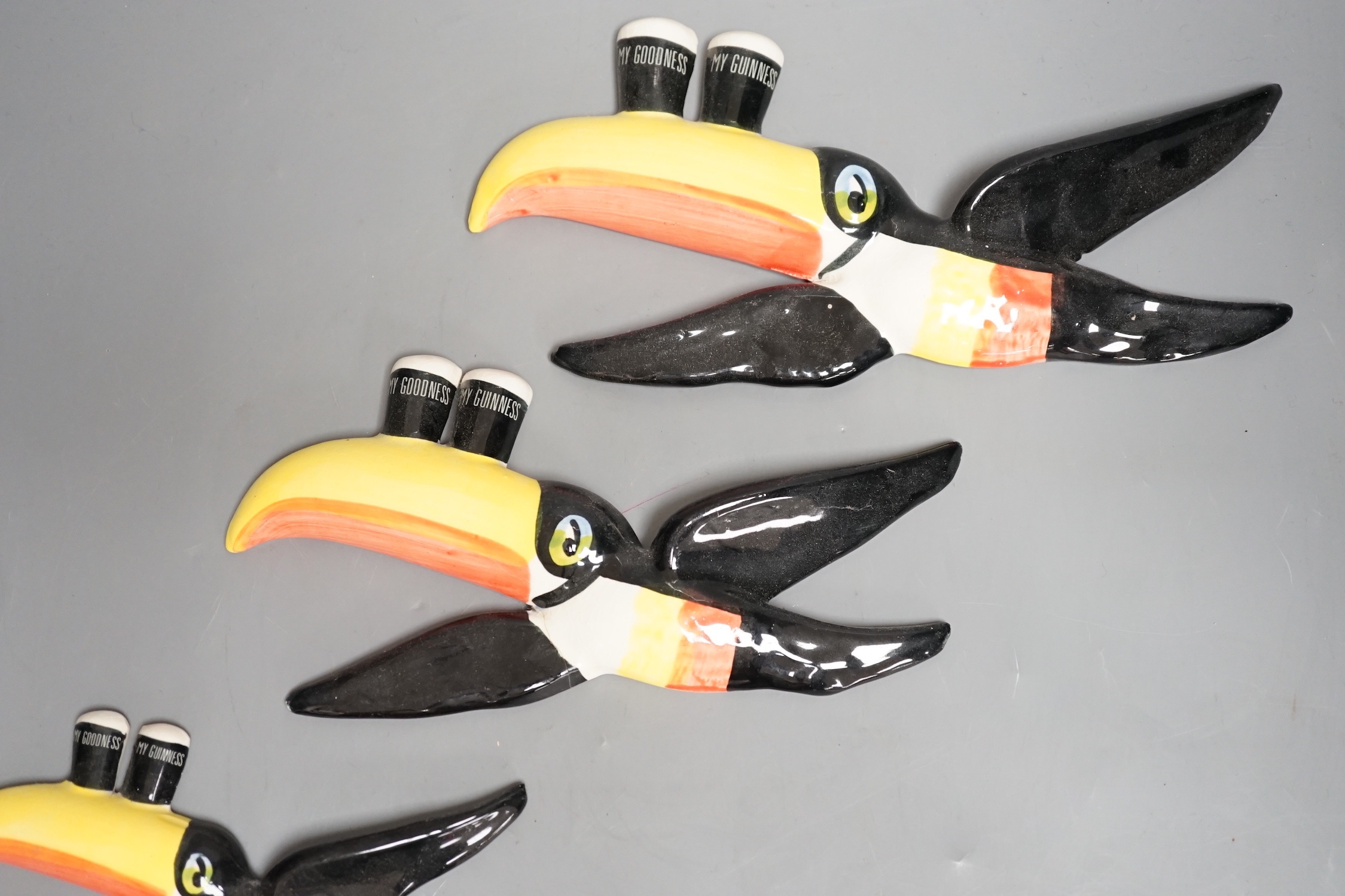 A graduated set of three Carlton ware toucan wall plaques